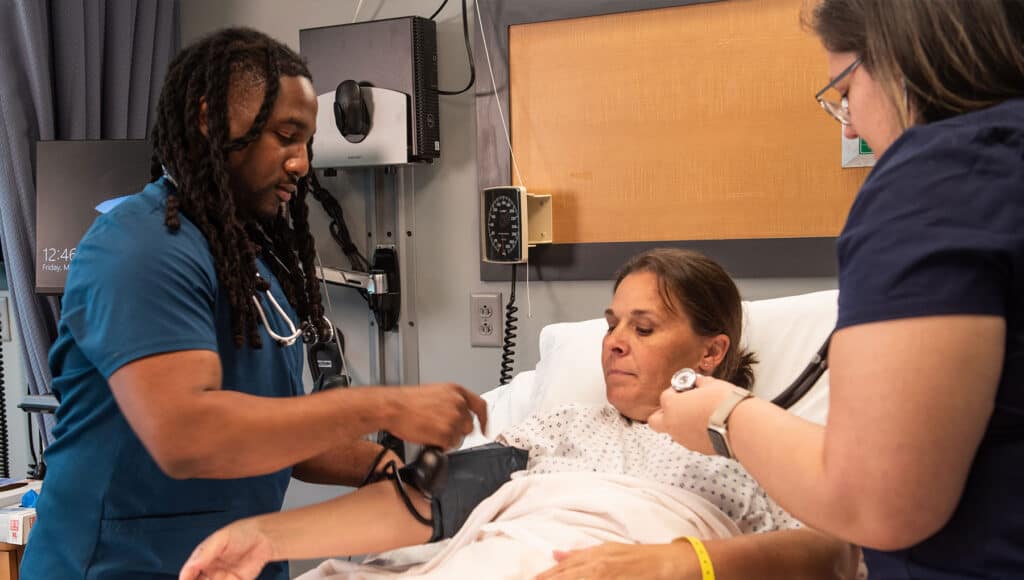 A nurse checking the blood pressure of a patient