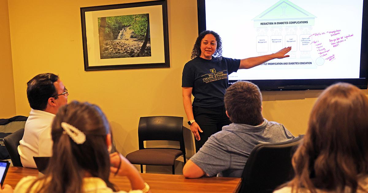 One of the tutors leads a group discussion on the new TV which allows you to mirror your screen.