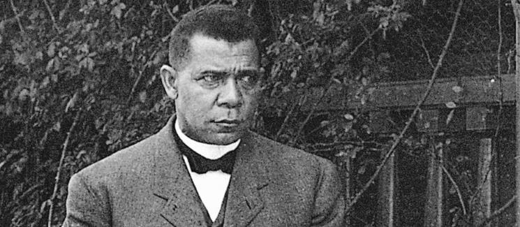Booker T. Washington in front of foliage