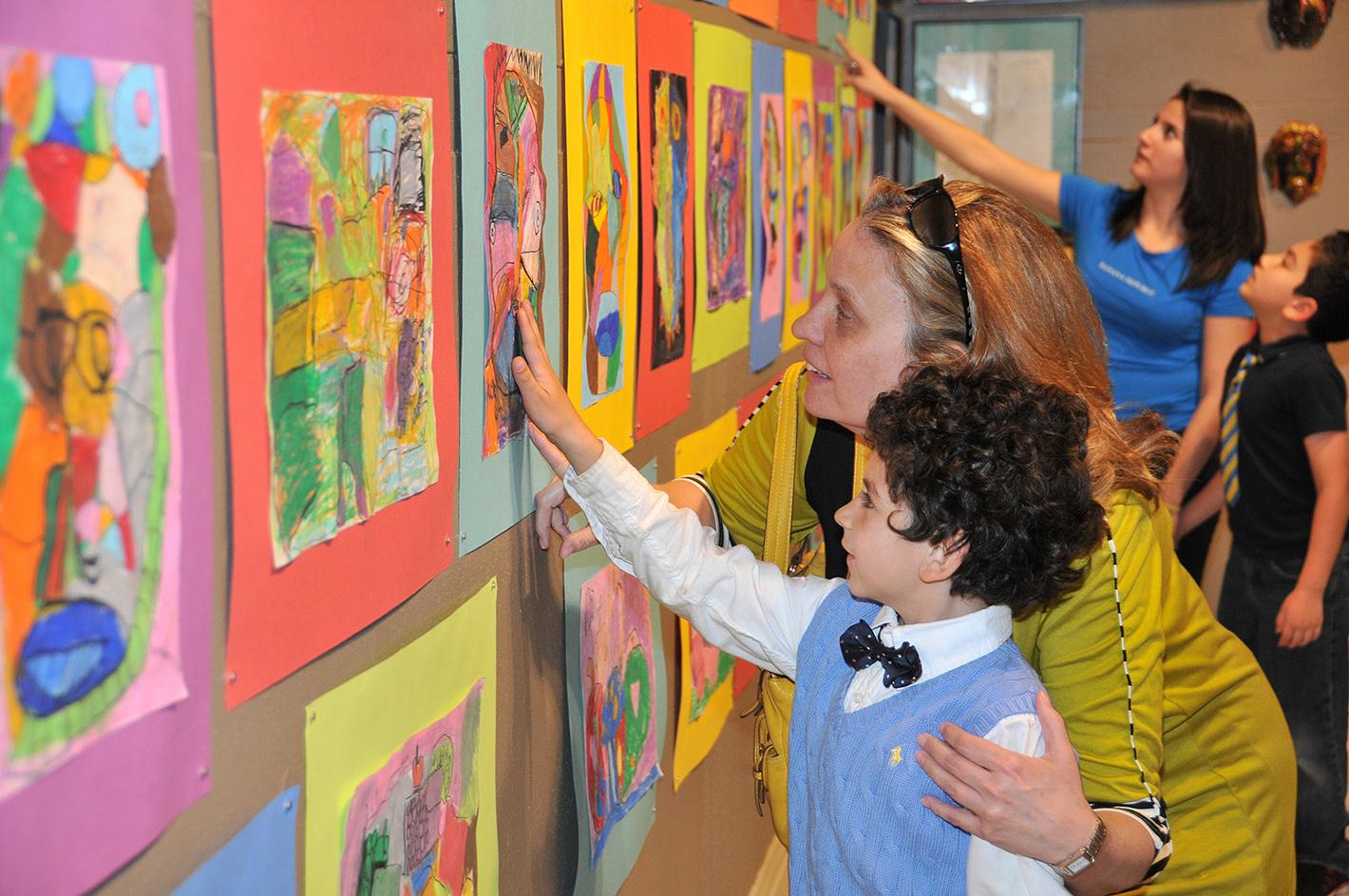 A young artist views his work in the exhibition Exuberance! Kids Make Art about Art curated by Sammie Nicely. The exhibition was in the Reece Museum in 2015.