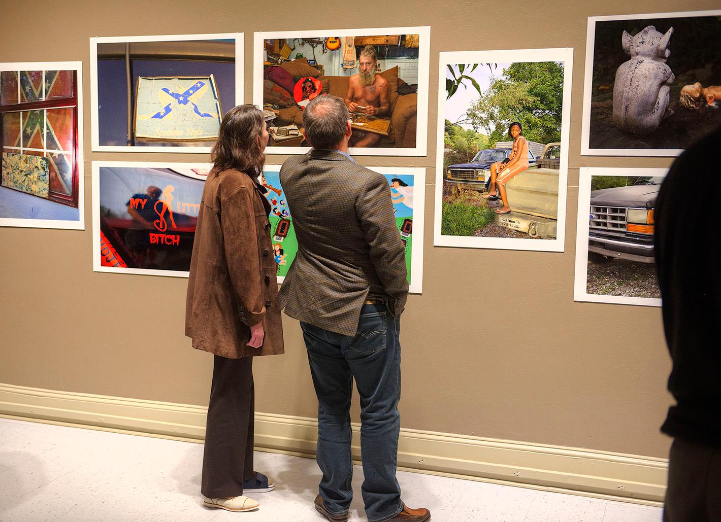 Visitors to the museum enjoy the works of Mike Smith in his solo exhibition entitled Parting Shots in 2017.