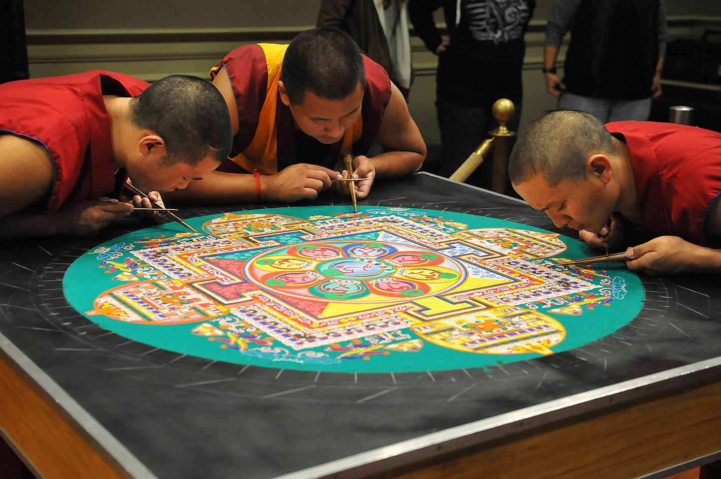 Tibetan monks creating a sand mandala. The monks were at the museum in 2014 as part of a visit sponsored by the Mary B. Martin School of the Arts.