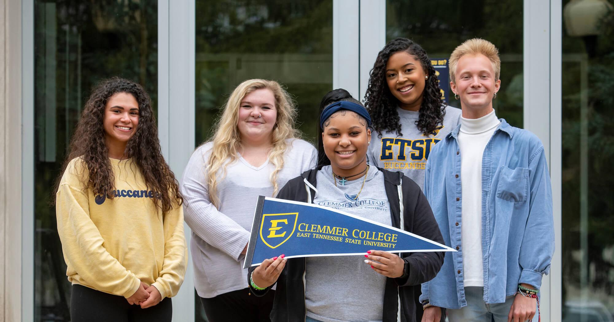 Clemmer students in front of Warf-Pickel holding Pennant. 