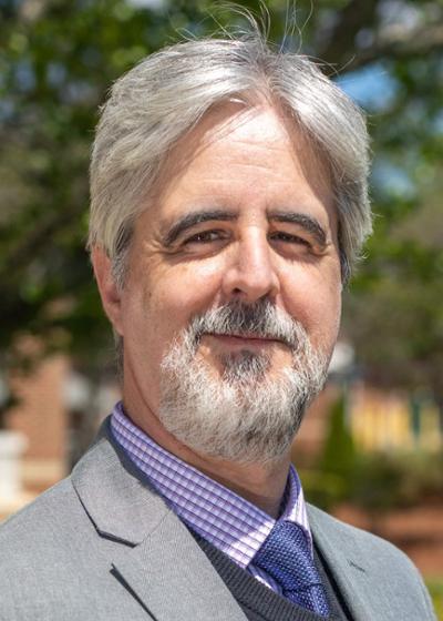 Dr. Diego Rodriguez-Gil, Associate Professor of Biomedical Sciences Department pictured wearing a suit and tie. of Diego Rodriguez-Gil