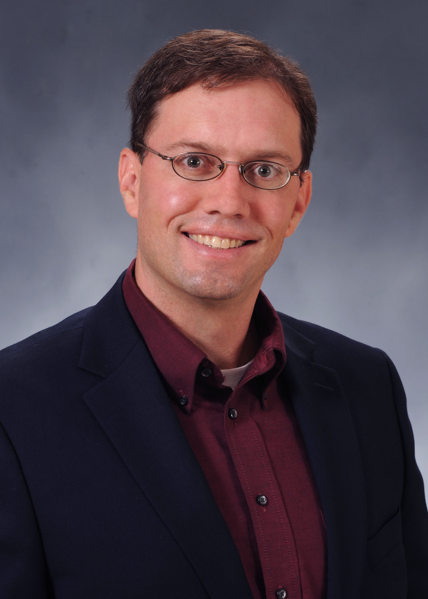 Dr. Patrick Bradshaw, Associate Professor of Biomedical Sciences Department pictured wearing a maroon shirt and black jacket. of Patrick Bradshaw