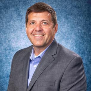Dr. Aaron Polichnowski, Associate Professor of Biomedical Sciences Department pictured wearing a suit and tie. of Aaron Polichnowski
