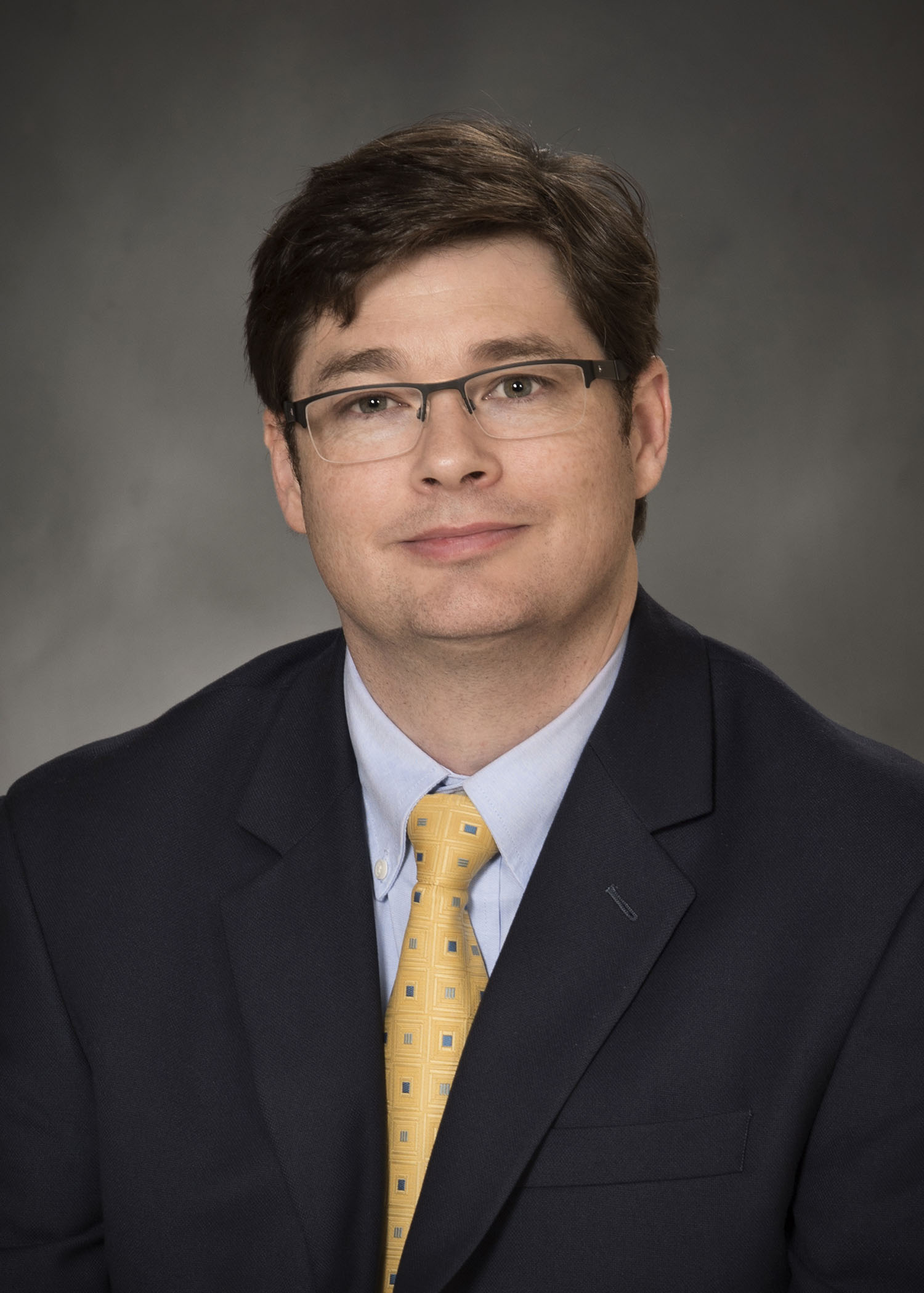 Dr. Tyrone Genade, Assistant Professor of Department of Medical Education pictured wearing a suit and tie. of Tyrone Genade