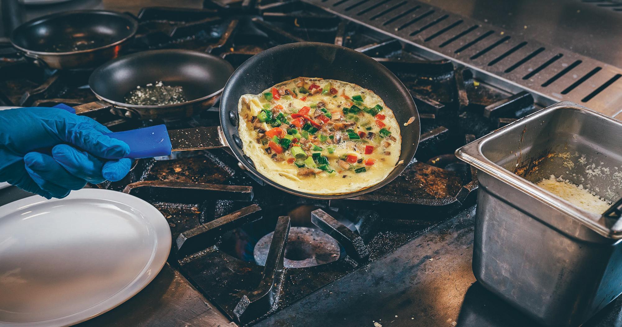 An omelette being prepared over a stove top in the 雷火体育 dining hall.